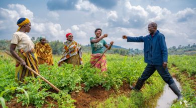 Ripple Effect farmer Joselyne in Burundi is congratulated by extension worker Johny Bukuru for securing a good price for her potato crop