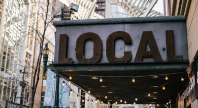 Close up photo shows large shop sign reading 'LOCAL' in capital letters